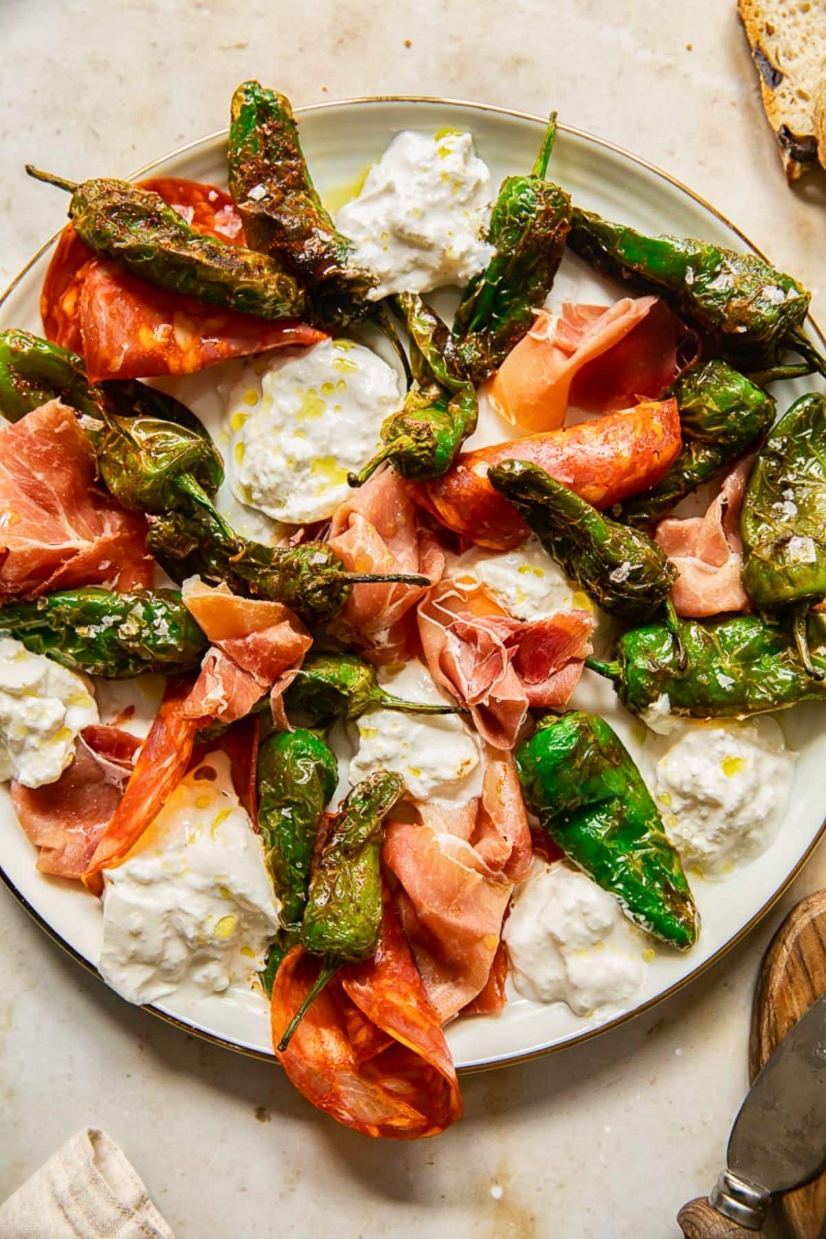 Scrumptious Padron Peppers, serrano ham and manchego cheese on a tray.