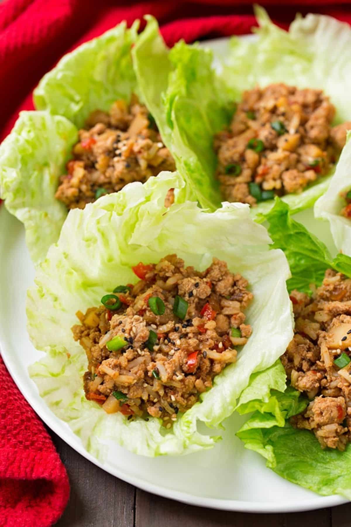 Healthy Slow Cooker Asian Chicken Lettuce Wraps on a white plate.