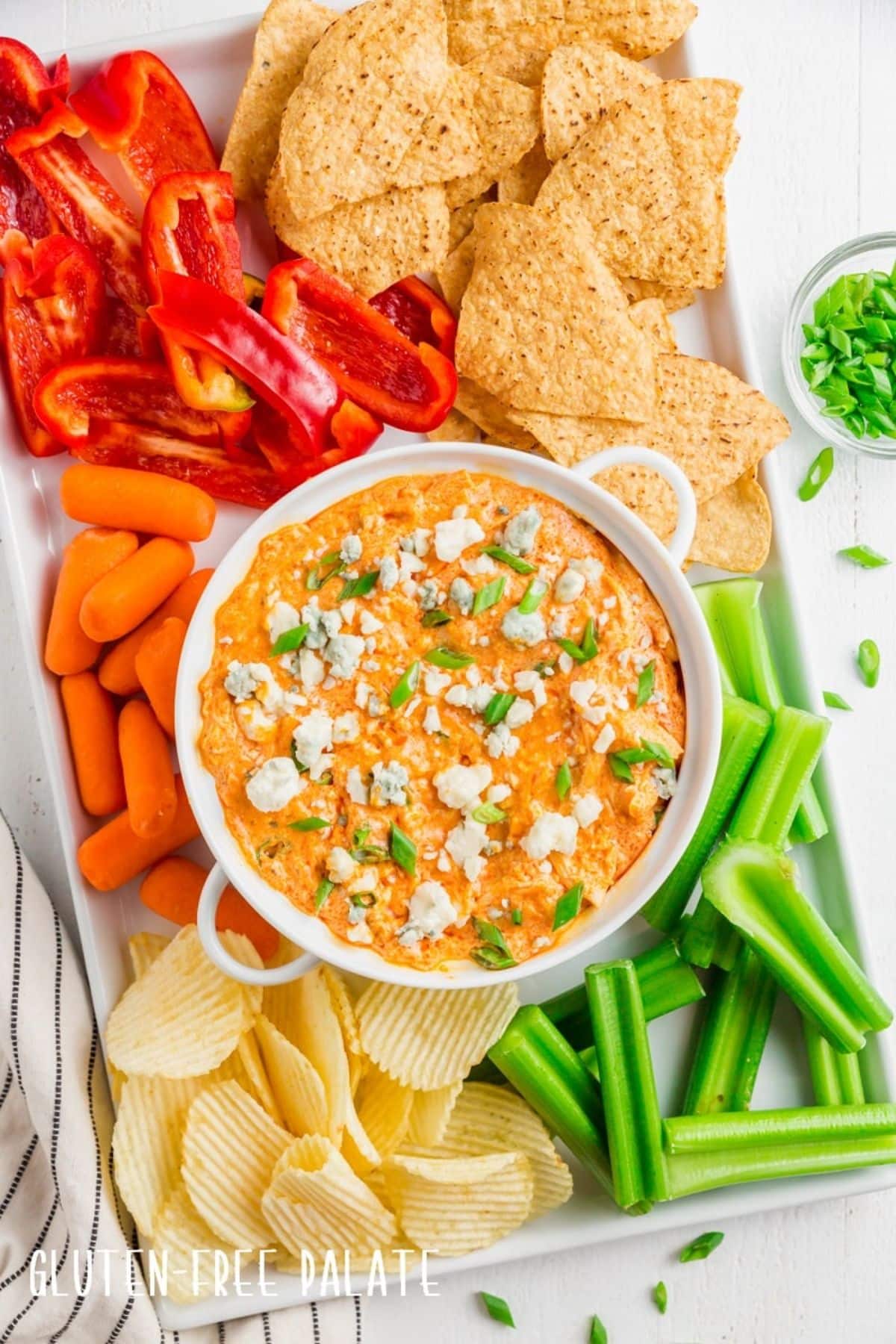 Flavorful Instant Pot Buffalo Chicken Dip in a white bowl on a tray.