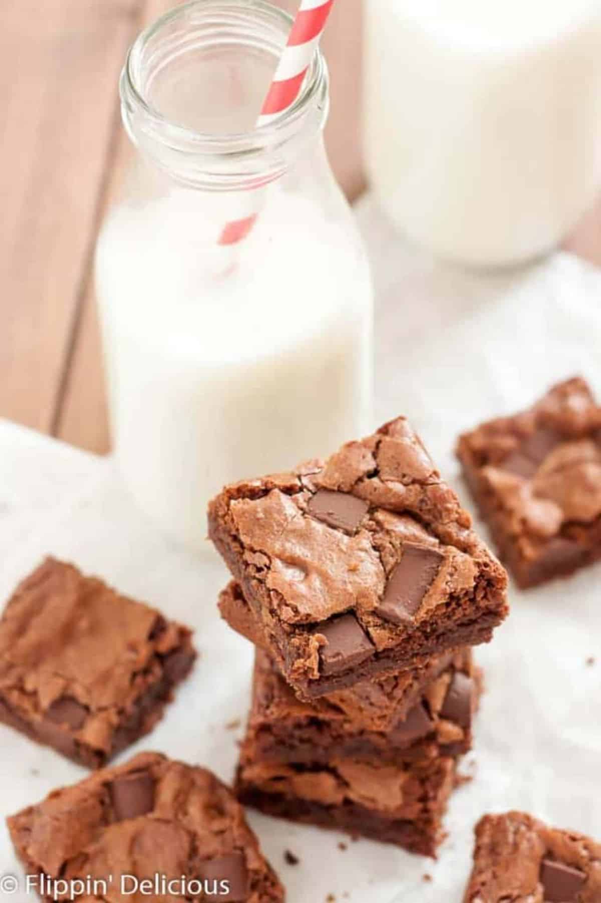 Flavorful Gluten-Free Brownies with a jar of milk on a table.