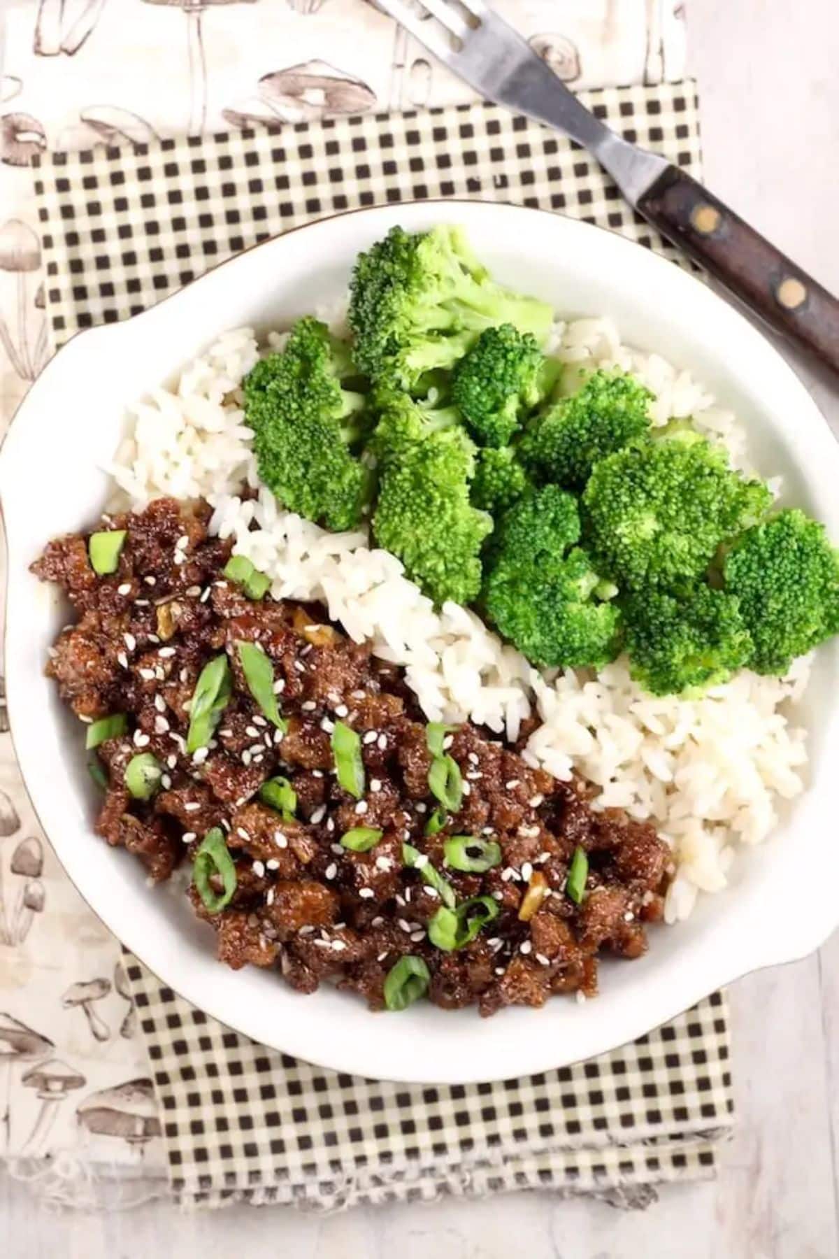 Tasty Korean Ground Beef and Broccoli with rice on a white plate.