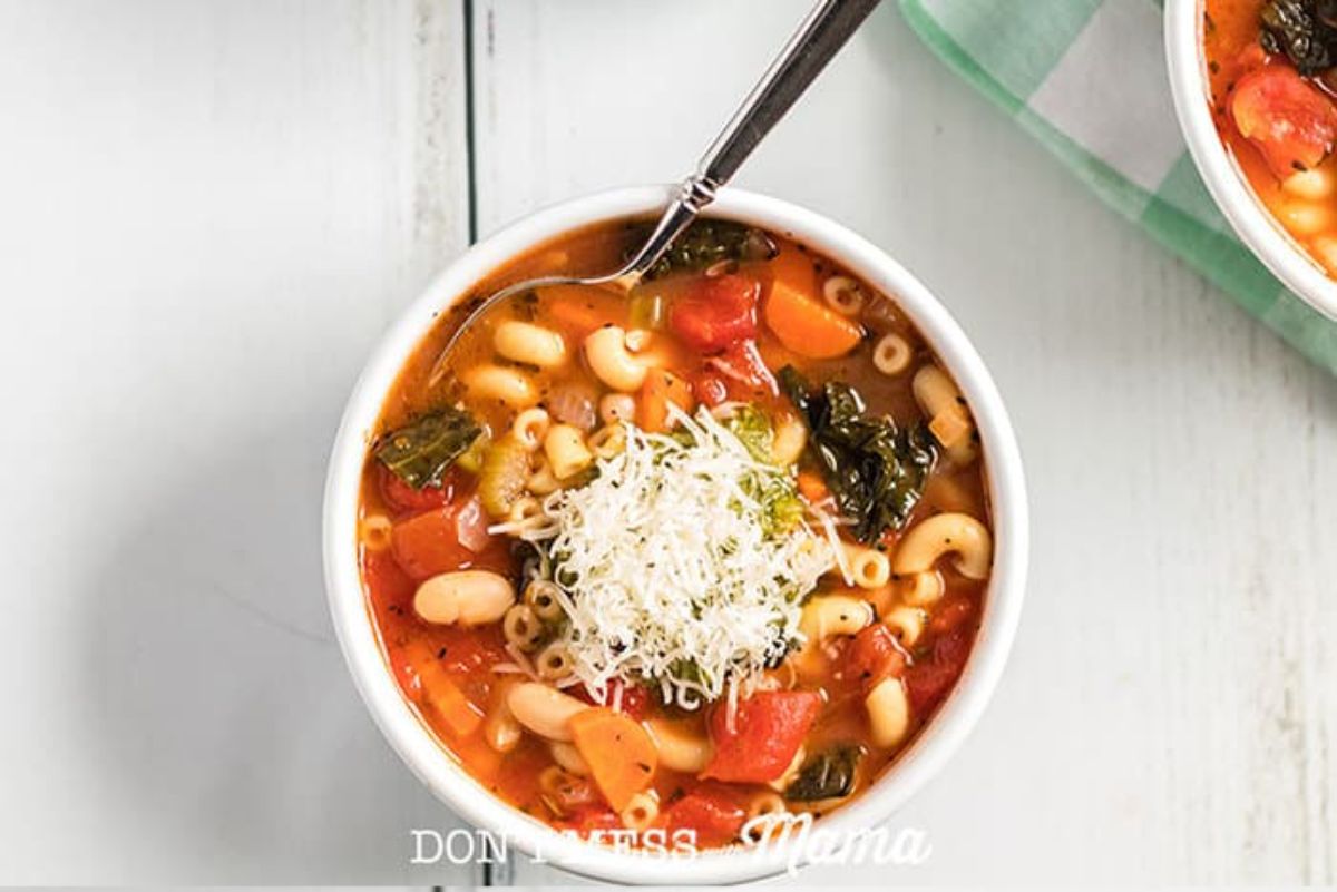 Scrumptious Instant Pot Minestrone Soup in a whote bowl with a fork.