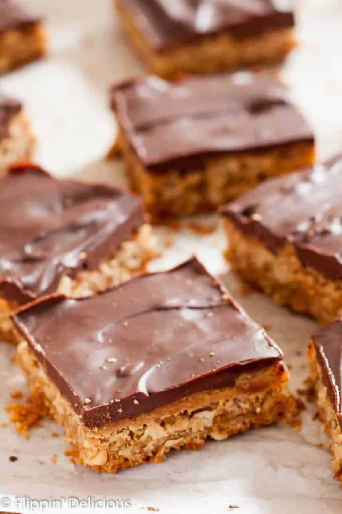 Scrumptious Gluten-Free Peanut Butter Bars with Chocolate Ganache on a table.