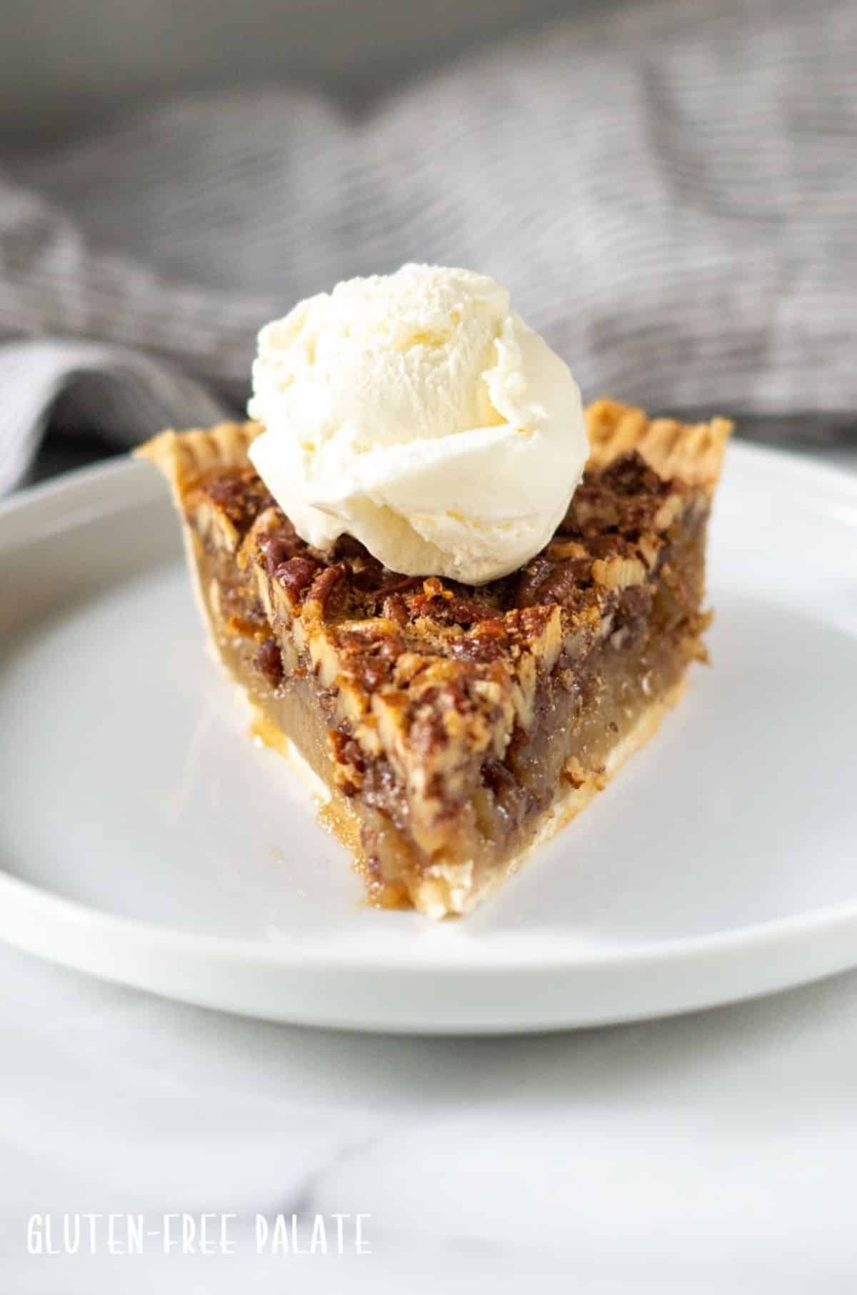 A piece of Gluten-Free Pecan Pie on a white plate.