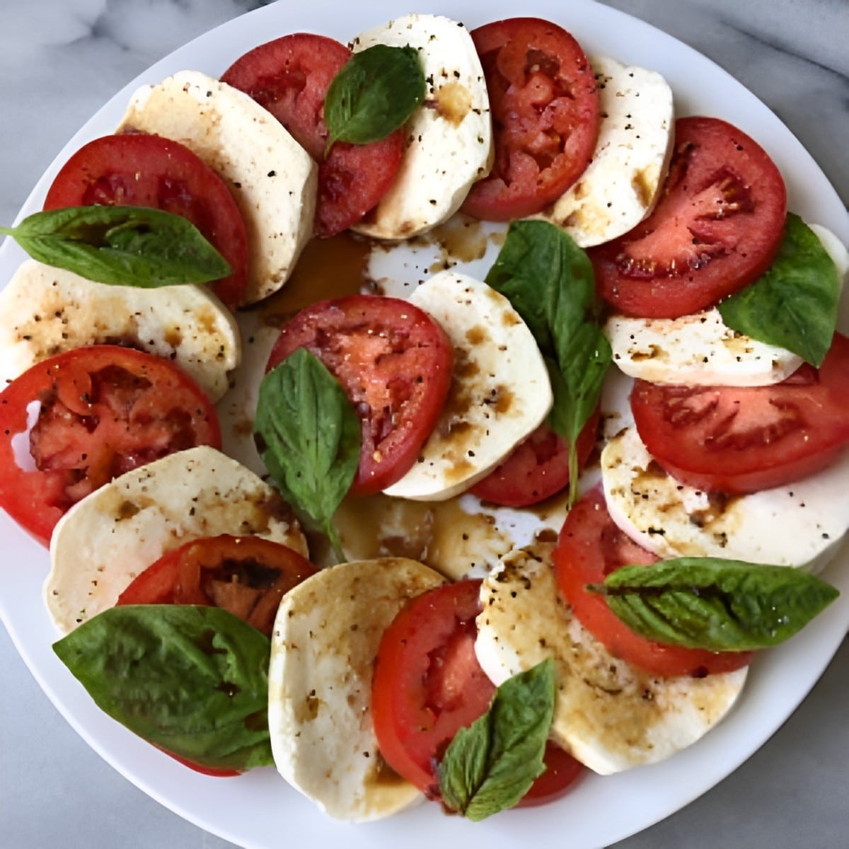 Healthy gluten-free Caprese Salad on a white plate.