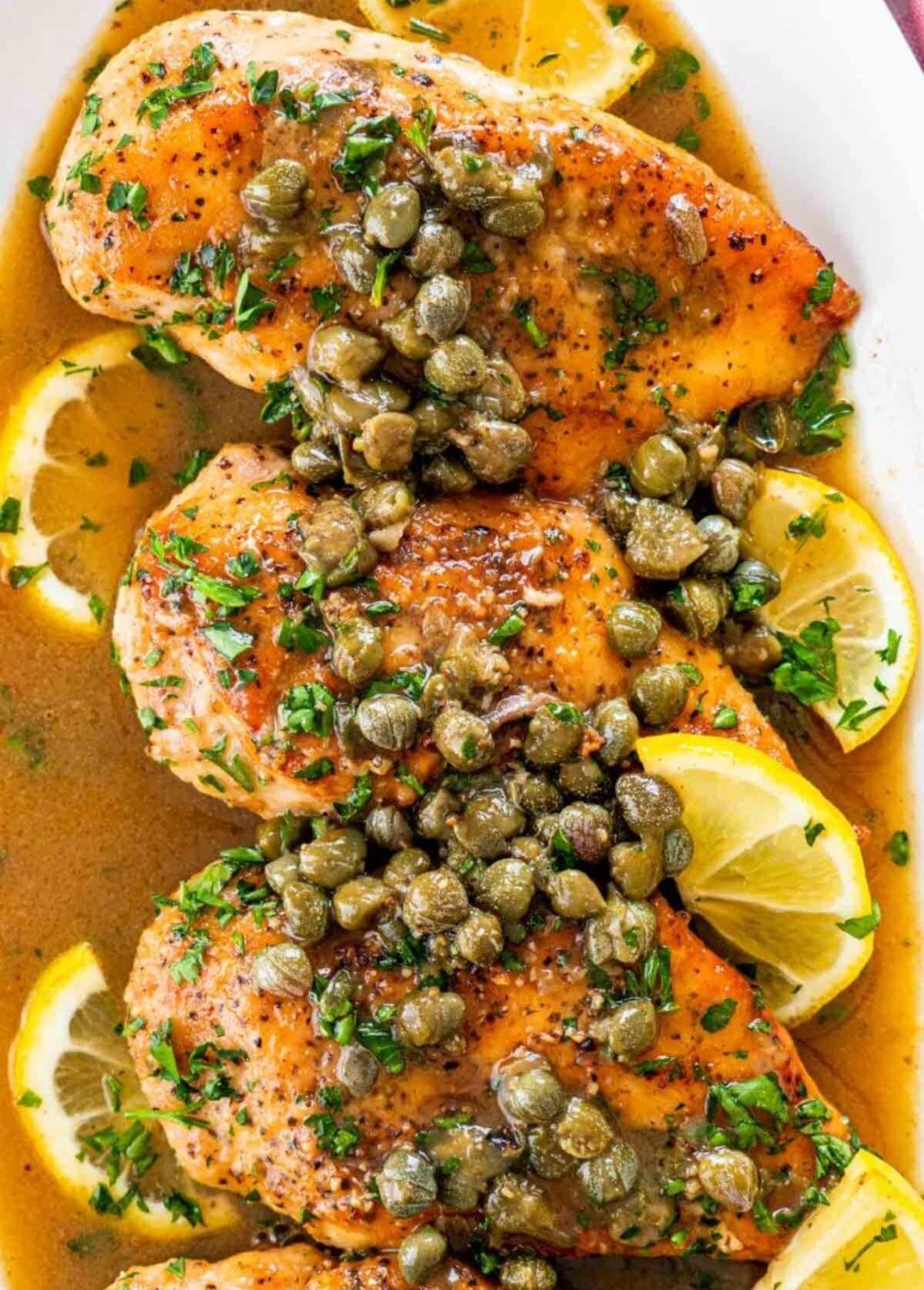 Scrumptious Lemon Chicken Piccata on a white tray.