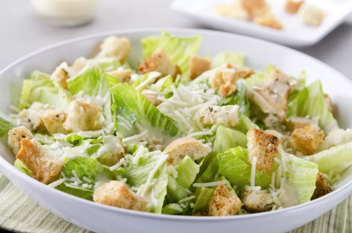 Healthy gluten-free Caesar Salad in a white bowl.