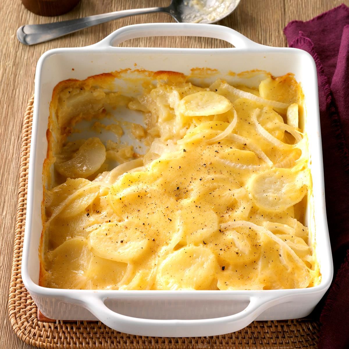Flavorful Never-Fail Scalloped Potatoes in a white casserole.