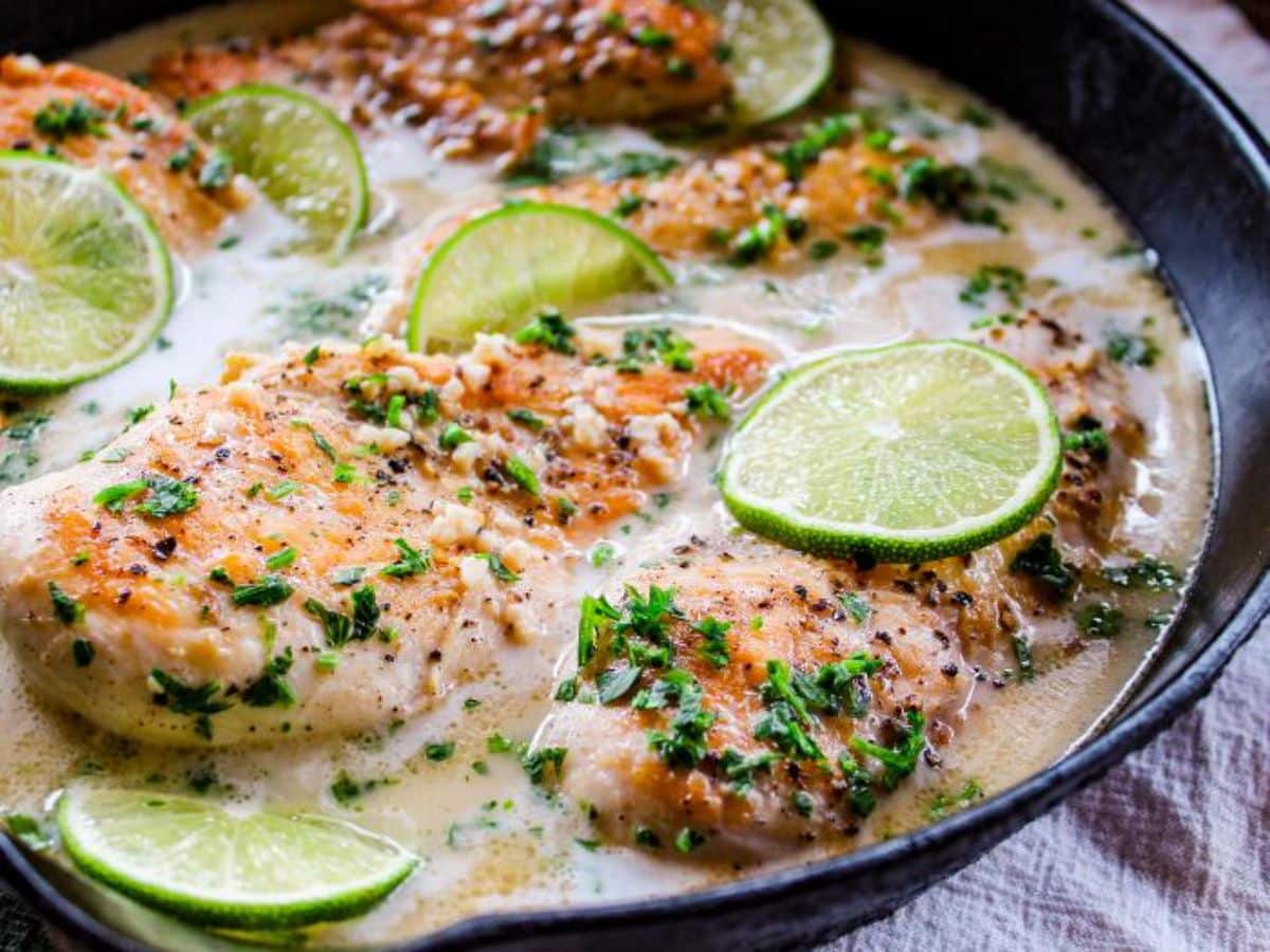 Juicy Coconut Lime Chicken in a black skillet.