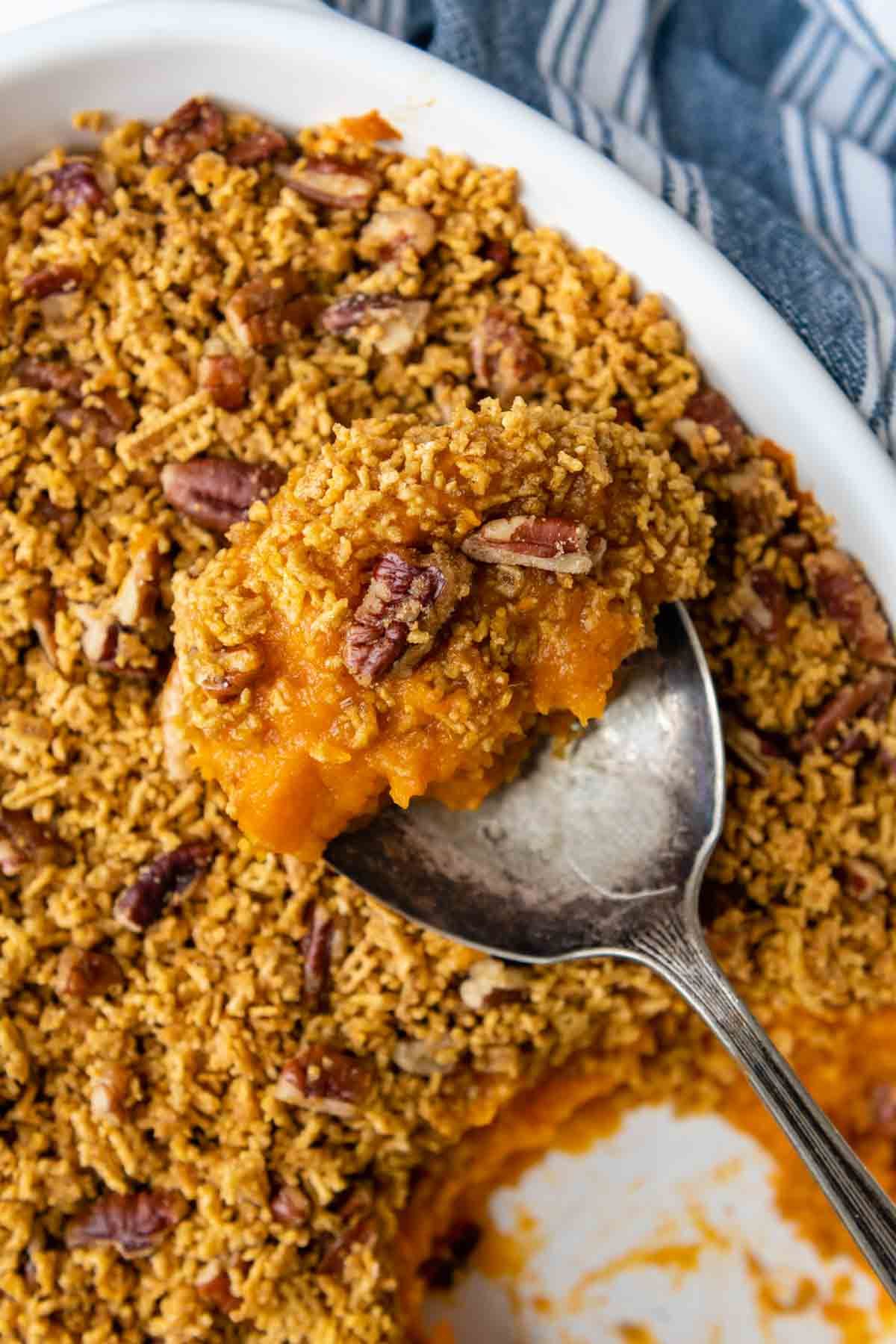 Gluten-Free Sweet Potato scooped by a spoon in a white casserole.