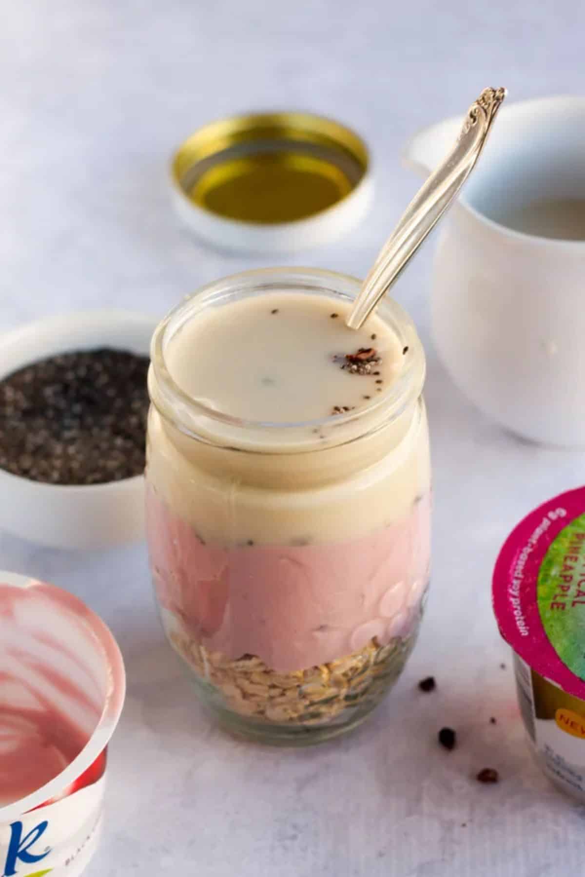 Healthy Black Cherry Cacao Dairy-Free Overnight Oats in a glass jar with a spoon.
