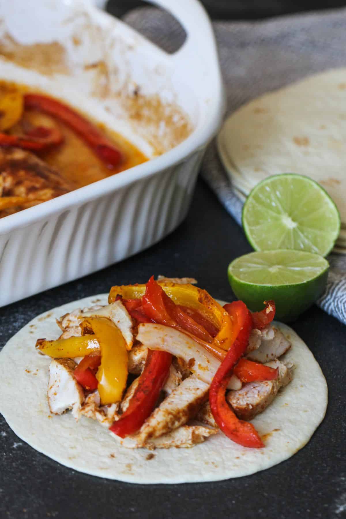 Mouth-watering One Pan Baked Fajitas on tortilla.