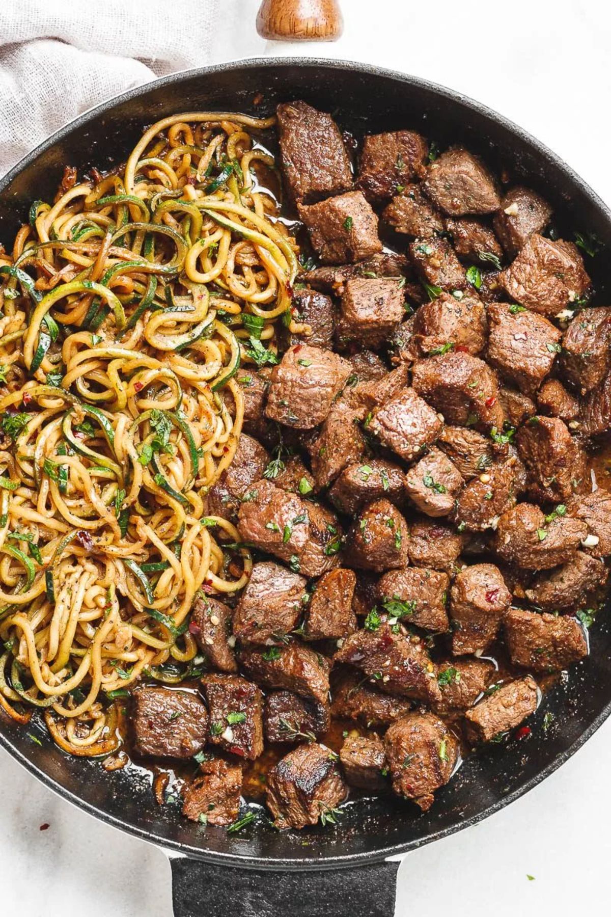 Delicious Garlic Butter Steak Bites on a black skillet.