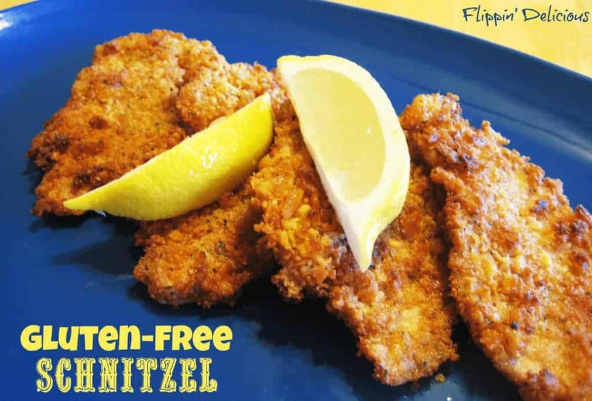Crispy Gluten-Free Schnitzels with slices of lemon a blue tray.