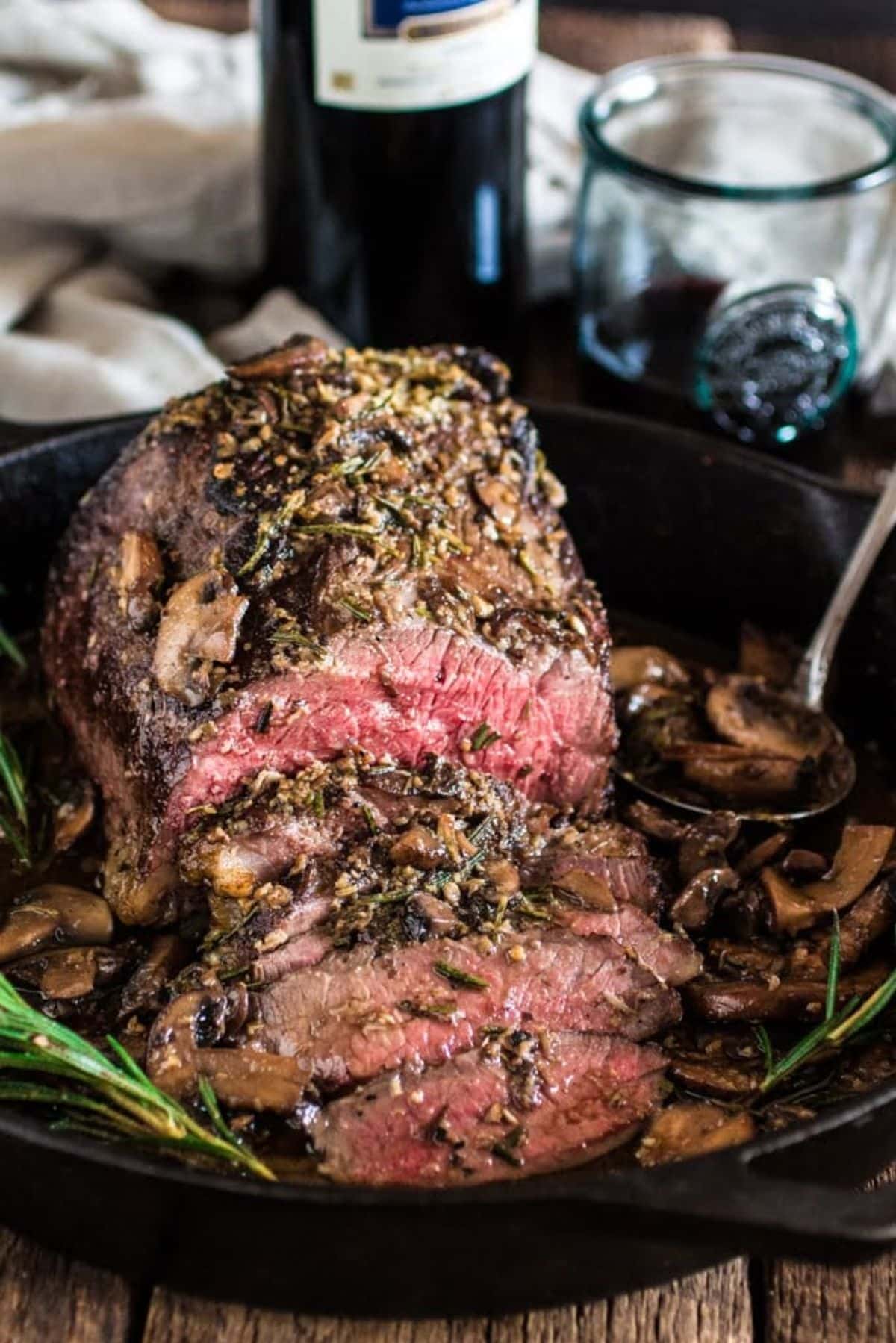 Mouth-watering Rosemary and Garlic Roast Beef in a black skillet.
