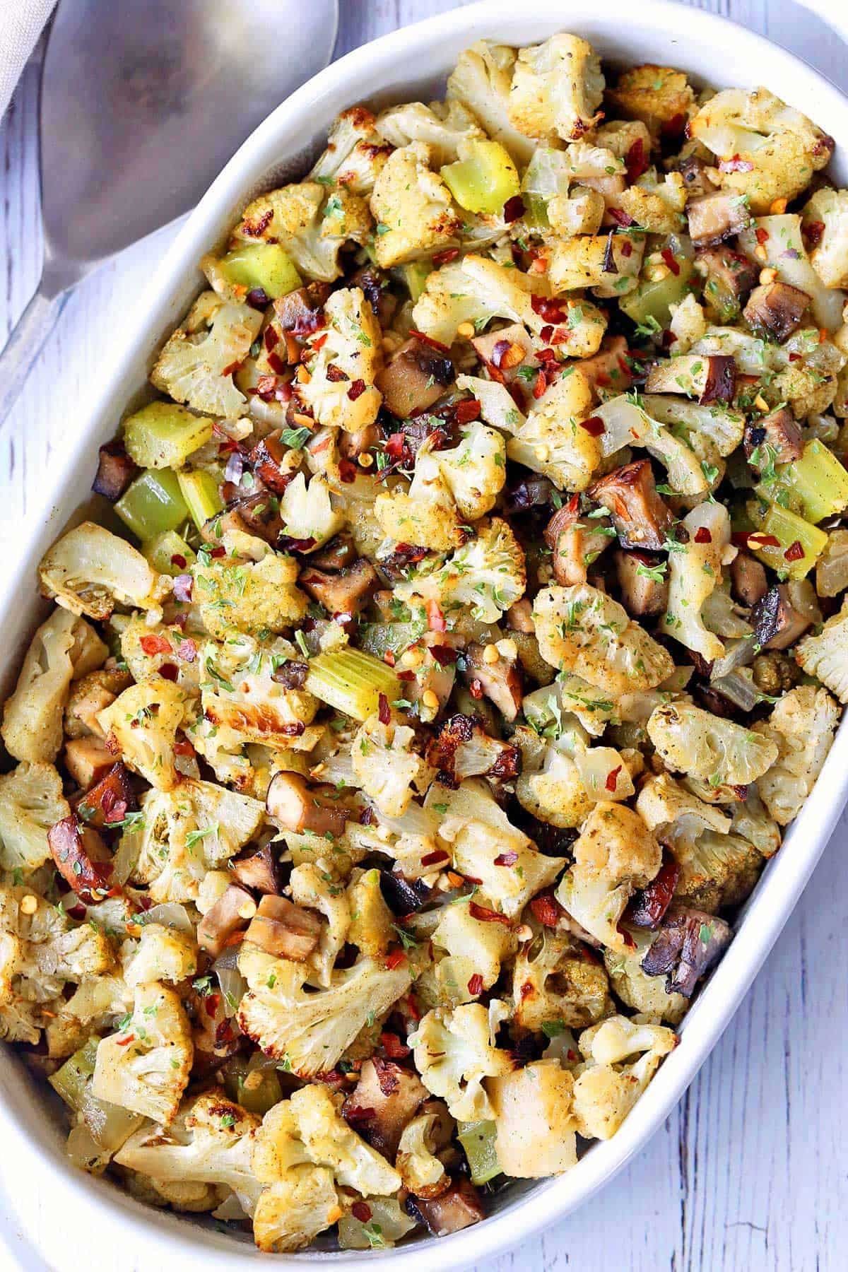 Flavorful Cauliflower Stuffing in a white casserole.