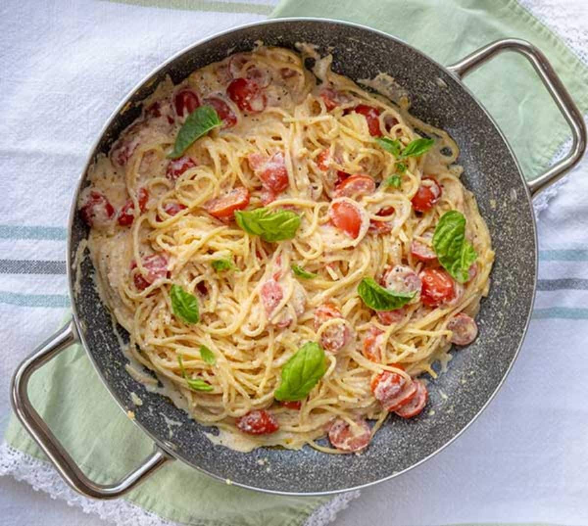 Healthy 15-Minute Gluten-Free Pasta With Garlic, Ricotta, & Tomatoes in a skillet.