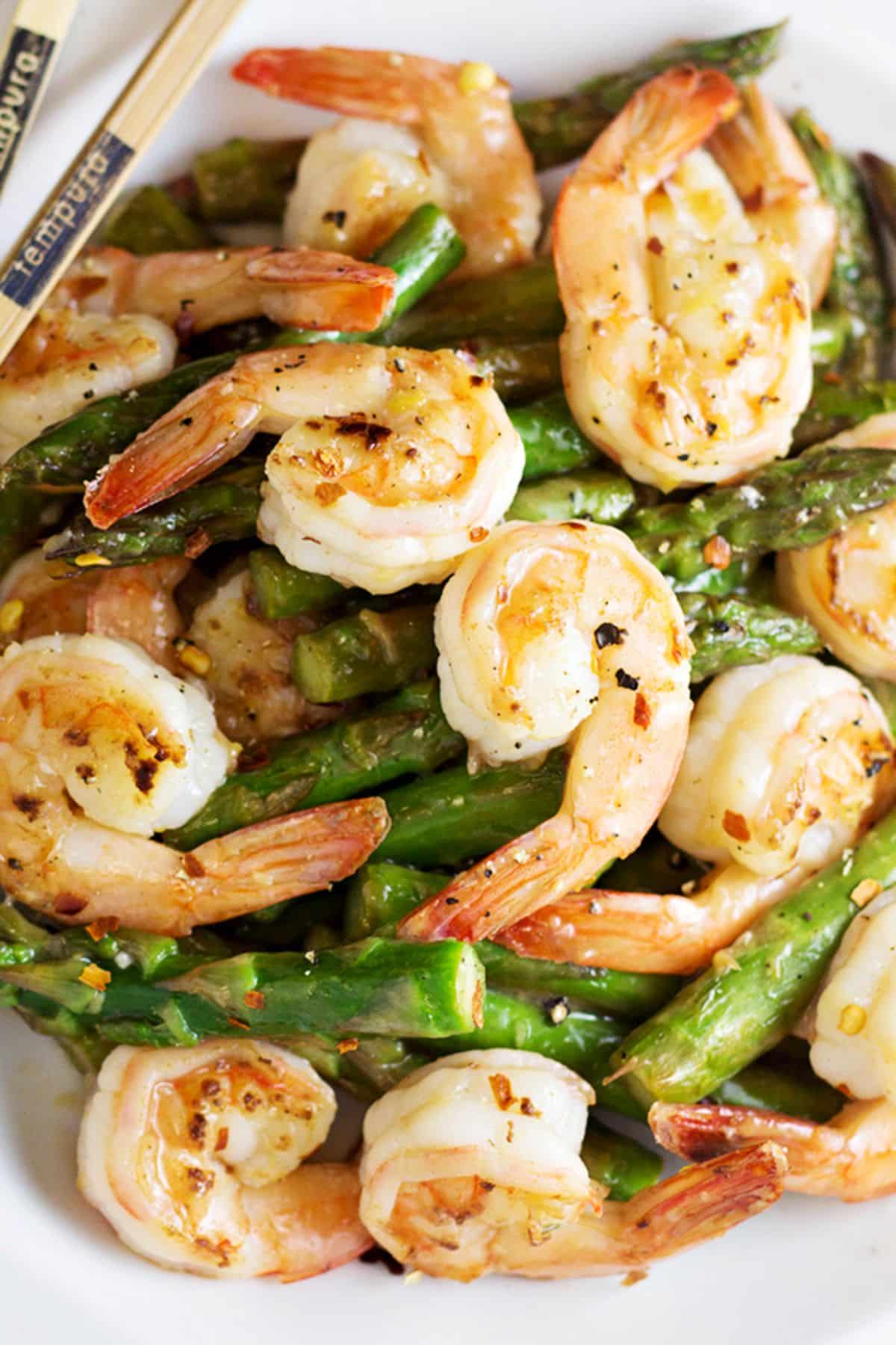 Scrumptious Shrimp and Asparagus Stir Fry with Lemon Sauce on a white plate.