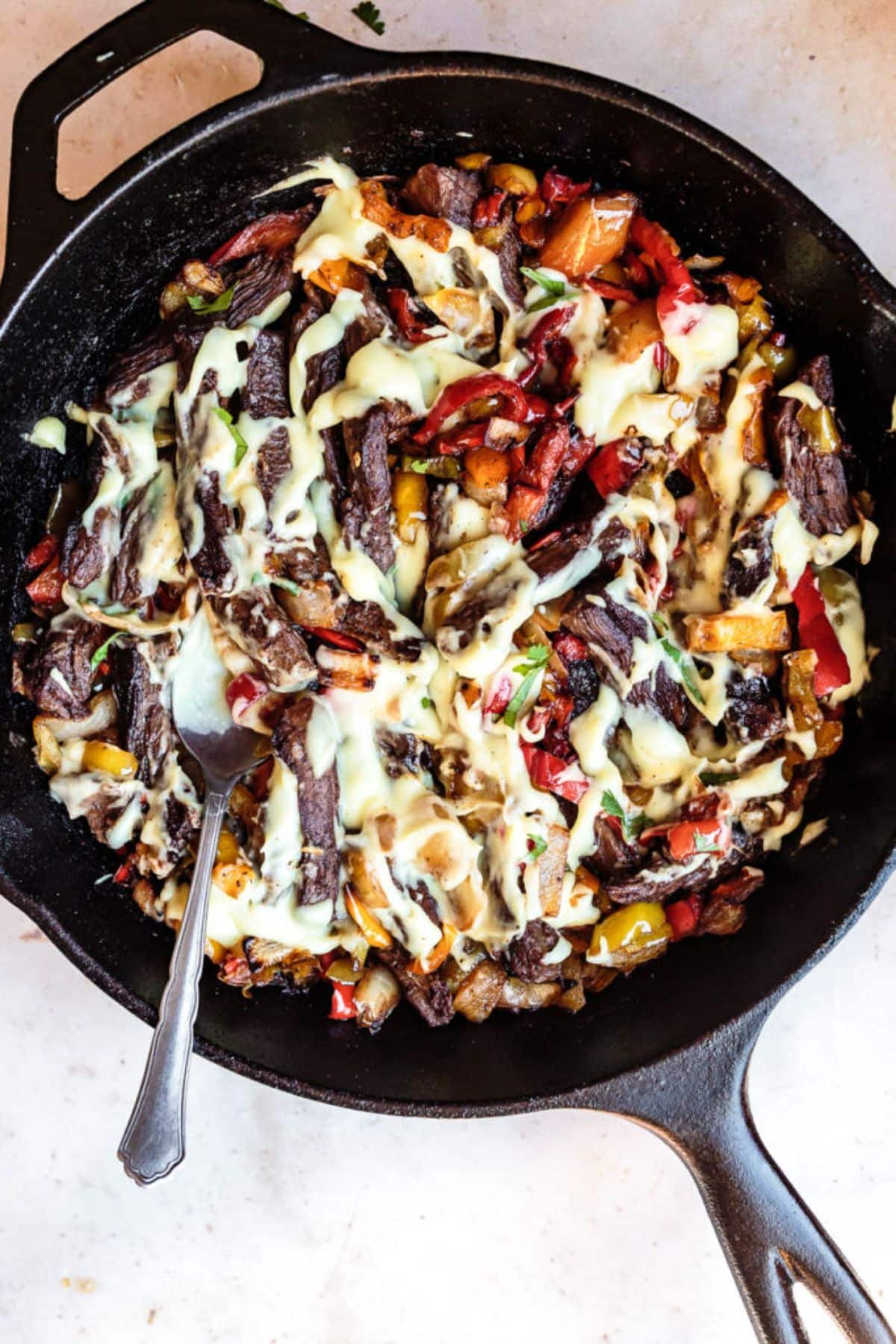 Delicious 30-Minute Philly Cheesesteak in a black skillet.