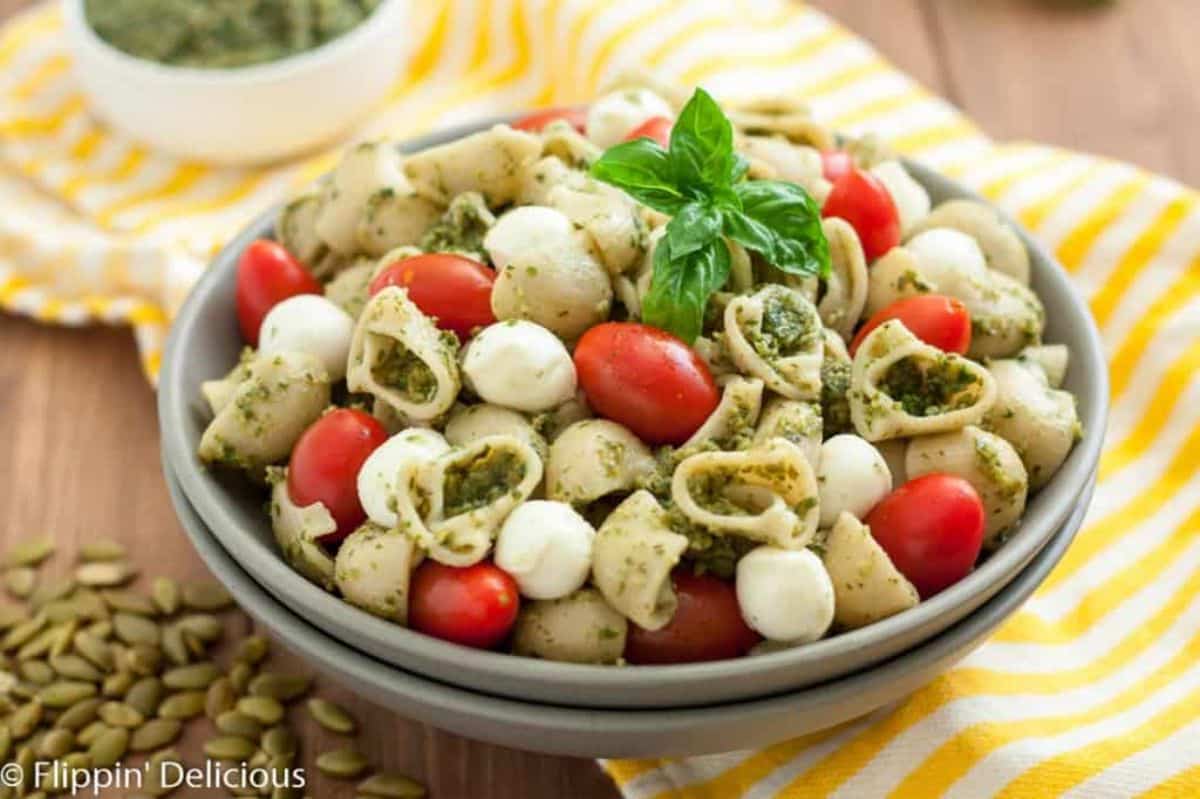 Healthy Gluten-Free Pasta Salad With Pumpkin Seed Pesto in a gray bowl.