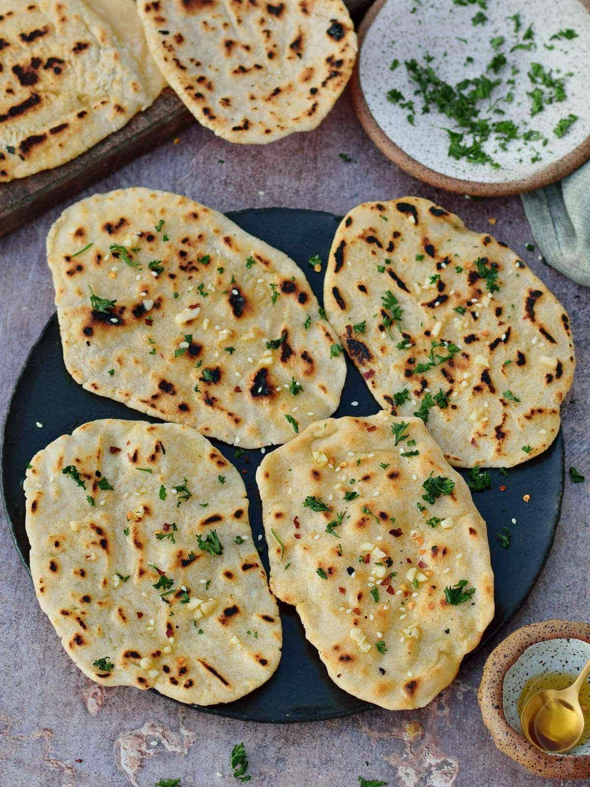 Crunchy Gluten-Free Naan on a black tray.