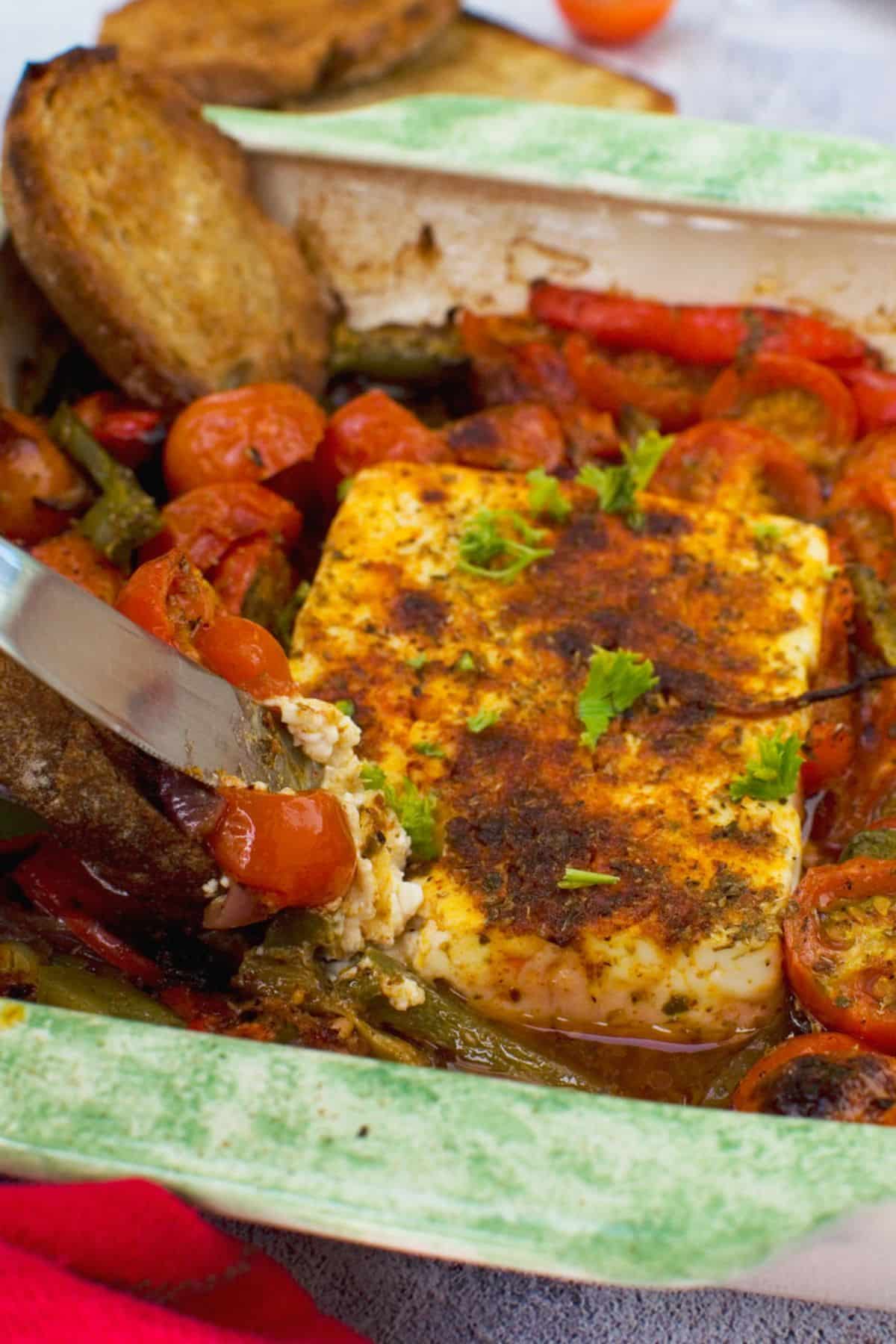 Crispy Baked Feta with Tomato and Red Pepper in a casserole.
