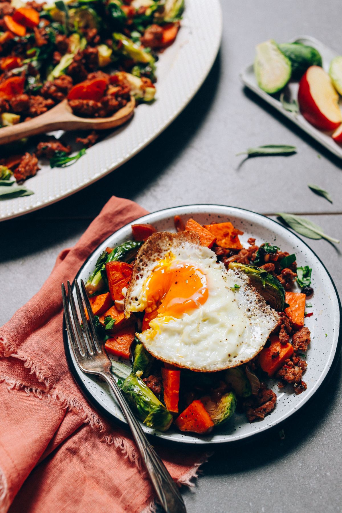 Delicious Breakfast Hash with Brussels Sprouts and Sweet Potatoes on a plate with a fork.