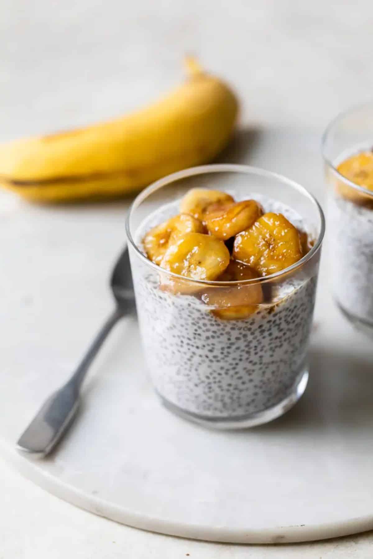 Scrumptious Coconut Chia Pudding with banana slices in a glass cup.