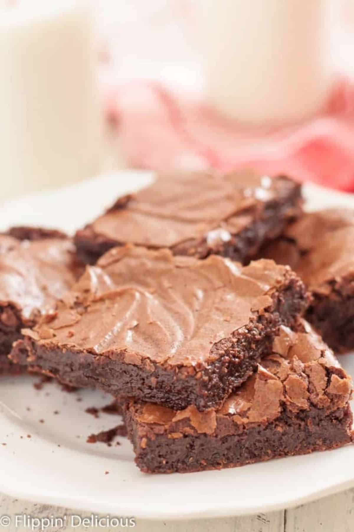 Scrumptious One Bowl Fudge Brownies on a white plate.