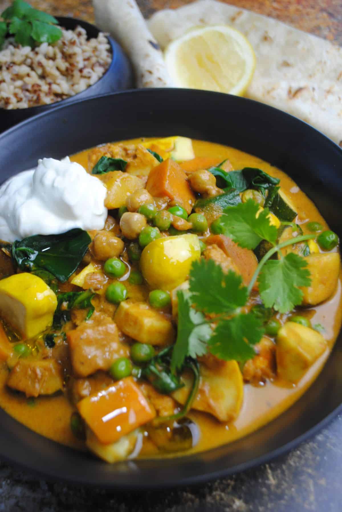 Delicious Indian Vegetable Curry in a black bowl.