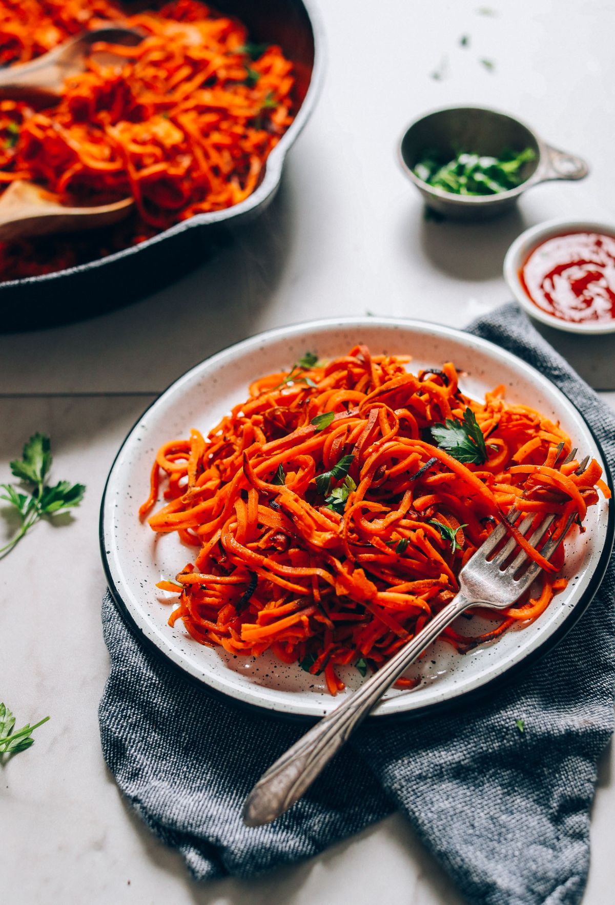 Healthy Two-Ingredient Gluten-Free Sweet Potato Hash Browns on a plate with a fork.