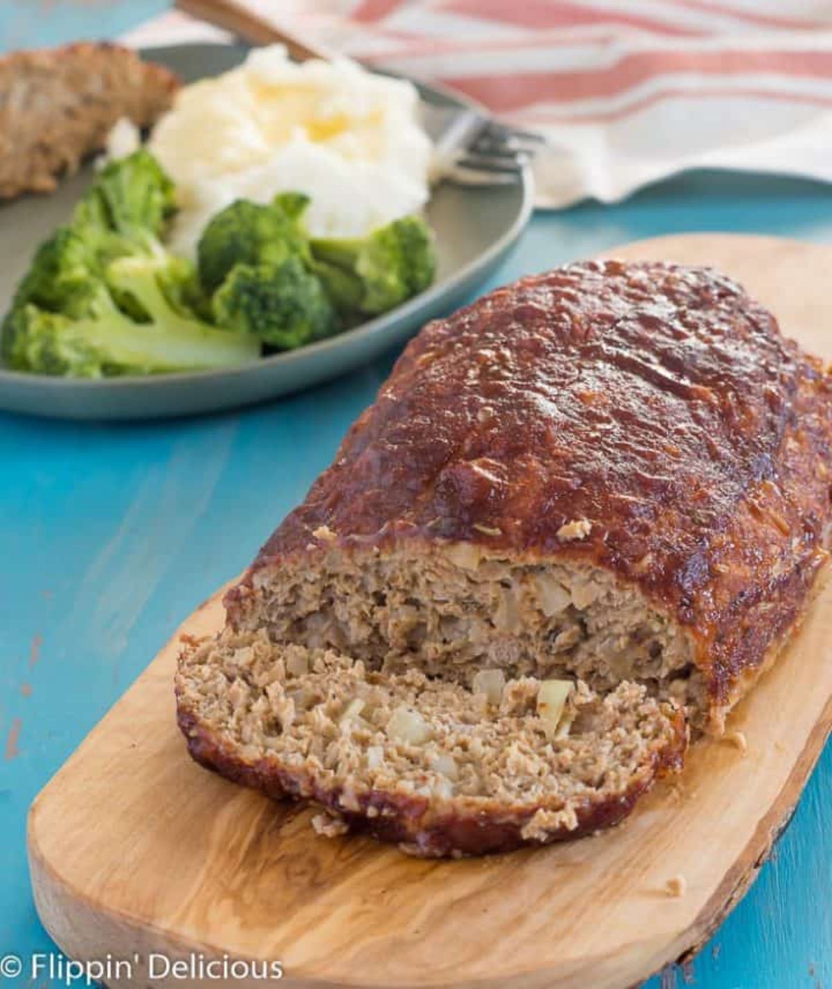 Juicy luten Free Turkey Meatloaf on a wooden tray.